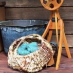 Blue handspun yarn in a brown wicker basket